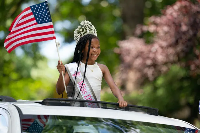 A girl representing Miss DMV Royalty waves from the roof of a car in the parade. The Takoma Park 4th of July parade was held on the morning of July 4th, 2023 in Takoma Park, MD. It was the 134th Independence Day celebration for the town and Congressman Jamie Raskin was the Grand Marshall for the parade. (Photo by Sarah L. Voisin/The Washington Post)