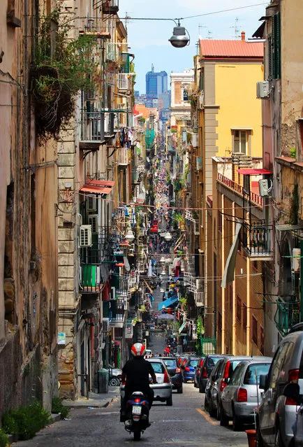 Runner-up. “This photograph was taken looking down the Via Pasquale Scura in Naples, Italy. It’s a chaotic city but with lots of history and some very friendly inhabitants”. MICK RYAN, JUDGE: “Cities have their landmarks and we all like to go home with photos of the sights as souvenirs. But off the beaten track is where the action happens, where you can witness the mass of humanity that calls the city home and a place of work. This is a great example of that, and the choice of the portrait format allows the eye to follow the road all the way through the frame”. (Photo by Peter Swan/The Guardian)