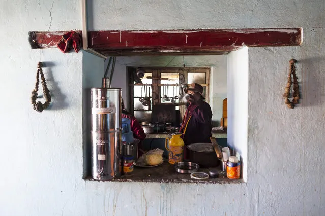 In this photograph taken on July 7, 2018, Indian Buddhist monk Nawang Tashi (R), 53, drinks tea in the kitchen of Tnagyud Gompa monastery in Komik in Spiti Valley in the northern state of Himachal Pradesh. (Photo by Xavier Galiana/AFP Photo)