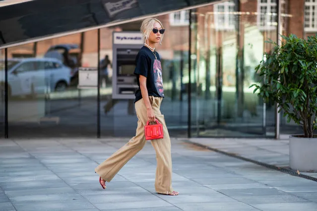 Vanessa Hong wearing band tshirt, beige pants, red bag is seen outside Designers Remix during the Copenhagen Fashion Week Spring/Summer 2019 on August 9, 2018 in Copenhagen, Denmark. (Photo by Christian Vierig/Getty Images)