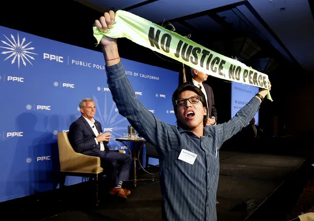Rep. Kevin McCarthy, R-Calif., listens as protester Basilio Hernandez and other immigrant activists interrupt his appearance with the Public Policy Institute of California, Wednesday, August 15, 2018, in Sacramento, Calif.(Photo by Rich Pedroncelli/AP Photo)