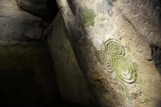 A neolithic engraving is seen during winter solstice inside the 5000 year old stone age tomb of Newgrange in the Boyne Valley at sunrise in Newgrange, Ireland, December 21, 2016. (Photo by Clodagh Kilcoyne/Reuters)