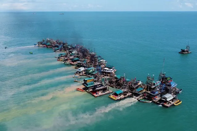 An aerial view shows wooden pontoons equipped to dredge the seabed for deposits of tin ore off the coast of Toboali, on the southern shores of the island of Bangka, Indonesia, May 1, 2021. Indonesia is the world's biggest exporter of tin used in everything from food packaging to electronics and now green technologies. But deposits in the mining hub of Bangka-Belitung have been heavily exploited on land, leaving parts of the islands off the southeastern coast of Sumatra island resembling a lunar landscape with vast craters and highly acidic, turquoise lakes. Miners are instead turning to the sea. (Photo by Willy Kurniawan/Reuters)