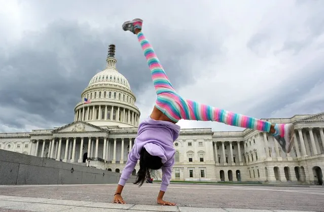 Valeria Ruiz, 10, from Colombia, does a cartwheel while visiting the U.S. Capitol, as Republican members of the House continue to work towards electing a new Speaker of the House in Washington, U.S., October 9, 2023. (Photo by Kevin Lamarque/Reuters)