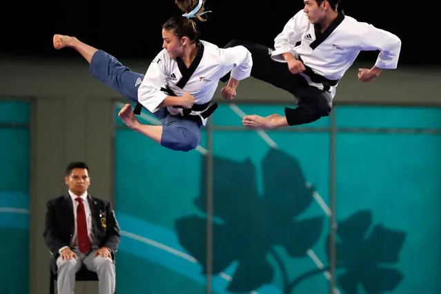 Independent Athletes Team's Maria Alejandra Higueros (L) and Hector Morales compete in the taekwondo mixed poomsae pairs cut off final during the Pan American Games Santiago 2023, at the Contact Sports Centre of the National Stadium Sports Park in Santiago on October 22, 2023. (Photo by Javier Torres/AFP Photo)