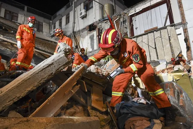 In this photo released by Xinhua News Agency, rescuers search for survivors at a collapsed hotel in Suzhou in eastern China's Jiangsu Province, Monday, July 12, 2021. The hotel building collapsed Monday afternoon. (Photo by Li Bo/Xinhua via AP Photo)