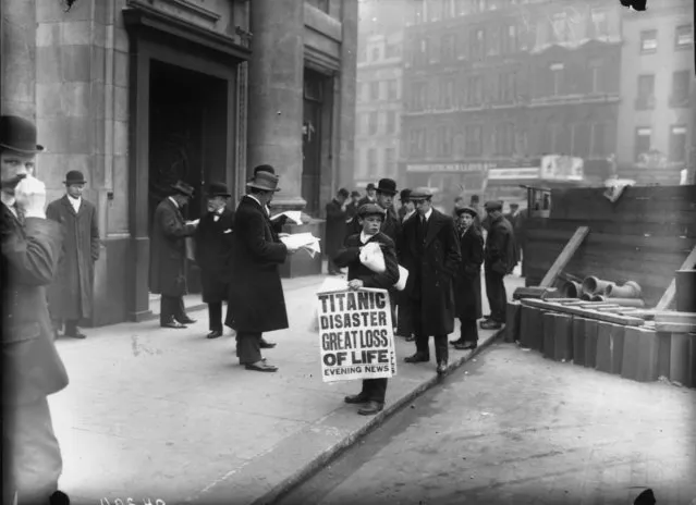 Newspaper boy Ned Parfett sells copies of the Evening News telling of the Titanic maritime disaster, outside the White Star Line offices at Oceanic House in London's Cockspur Street, 16th April 1912. Six years later Parfett was killed during a German bombardment whilst serving in France, just days before the end of World War I.   (Photo by Topical Press Agency/Getty Images)