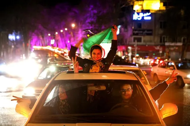 Iranians celebrate on a street in northern Tehran, Iran, Thursday, April 2, 2015, after Iran's nuclear agreement with world powers in Lausanne, Switzerland. (Photo by Ebrahim Noroozi/AP Photo)