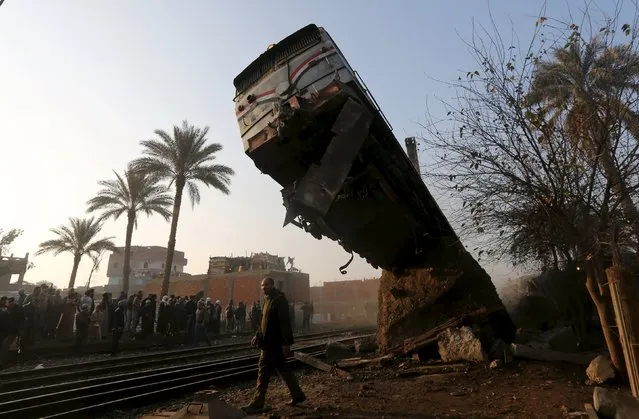A crowd looks at the wreckage of a train crash in Beni Suef, south of Cairo, February 11, 2016. (Photo by Mohamed Abd El Ghany/Reuters)