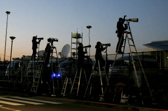 Photographers on ladders stand by outside the Tokyo Detention Centerbwhere former Nissan chairman Carlos Ghosn and former another executive Greg Kelly are being detained in Tokyo Friday, December 21, 2018. Japanese prosecutors added a new allegation of breach of trust against Ghosn on Friday, dashing his hopes for posting bail. (Photo by Shuji Kajiyama/AP Photo)