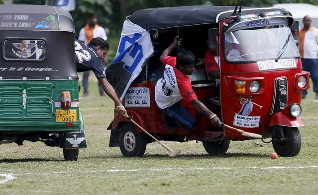 Competitors chase the ball during a “Tuk Tuk” (Three-Wheeled) Polo game in Galle, Sri Lanka on February 21, 2016. (Photo by Dinuka Liyanawatte/Reuters)