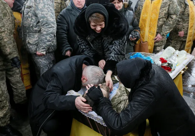 Relatives react during a funeral ceremony for Ukrainian serviceman Leonid Derhach, who was recently killed during a military conflict in the east of the country, in Independence Square in Kiev, Ukraine February 3, 2017. (Photo by Valentyn Ogirenko/Reuters)