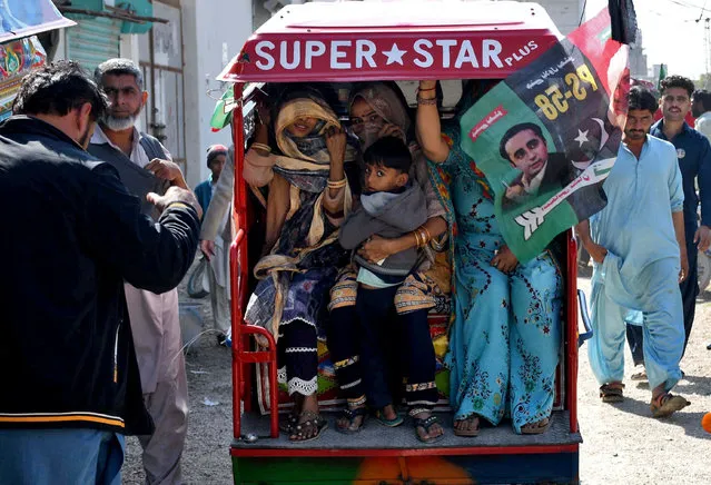 Hindu women travel in a tuk-tuk with a child after casting their votes during a general election, in Tando Allahyar, Sindh, Pakistan on February 8, 2024. (Photo by Yasir Rajput/Reuters)