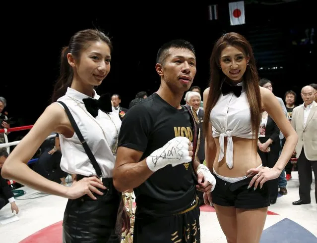 Takashi Uchiyama of Japan poses with ring girls after defeating Jomthong Chuwatana of Thailand by knockout in their WBA superfeather weight boxing title bout in Tokyo May 6, 2015. (Photo by Toru Hanai/Reuters)