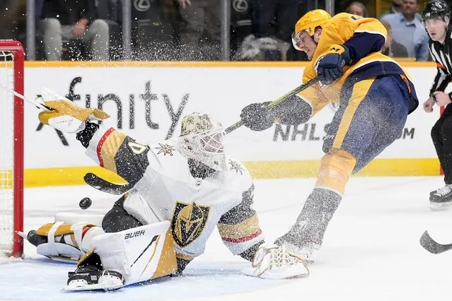 Vegas Golden Knights goaltender Jiri Patera (30) deflects a shot on goal by Nashville Predators defenseman Tyson Barrie, right, during the second period of an NHL hockey game Tuesday, March 26, 2024, in Nashville, Tenn. (Photo by George Walker IV/AP Photo)