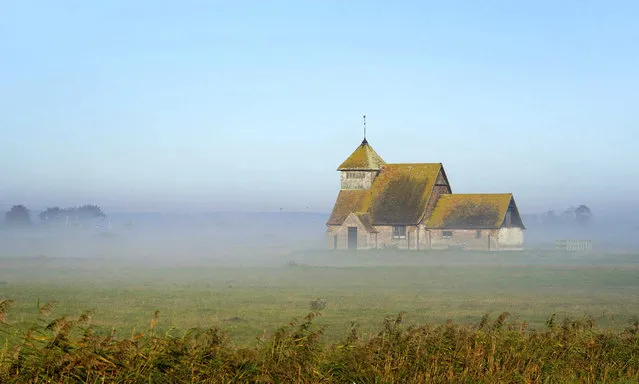 A view of St Thomas Becket church during the morning sunshine in Fairfield near Ashford, Tuesday November 2, 2021. The tiny building dates back to the late 12th century and sits isolated in a field cut through with dykes and grazed by sheep on the Romney Marsh in Kent. (Photo by Gareth Fuller/PA Wire via AP Photo)