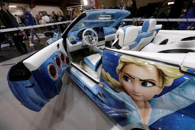 People look at a BMW convertible tuned in the style of Disney’s “Frozen” displayed at the “Auto Exotica 2016” car show in Riga, Latvia, April 15, 2016. (Photo by Ints Kalnins/Reuters)