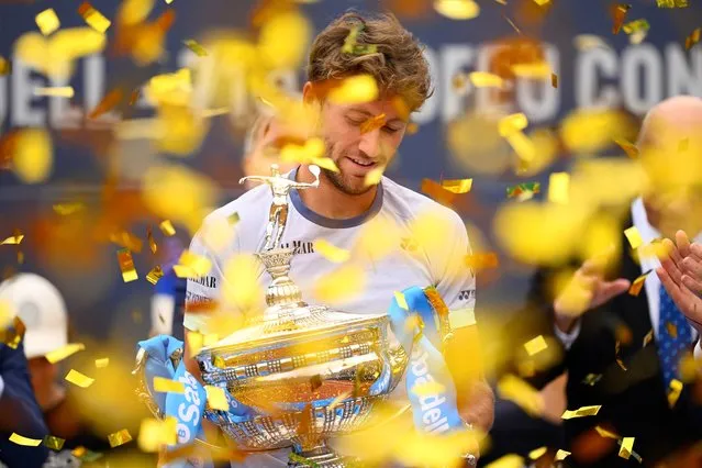 Norway's Casper Ruud holds the trophy after beating Greece's Stefanos Tsitsipas during the ATP Barcelona Open “Conde de Godo” tennis tournament singles final match at the Real Club de Tenis in Barcelona, on April 21, 2024. (Photo by Josep Lago/AFP Photo)