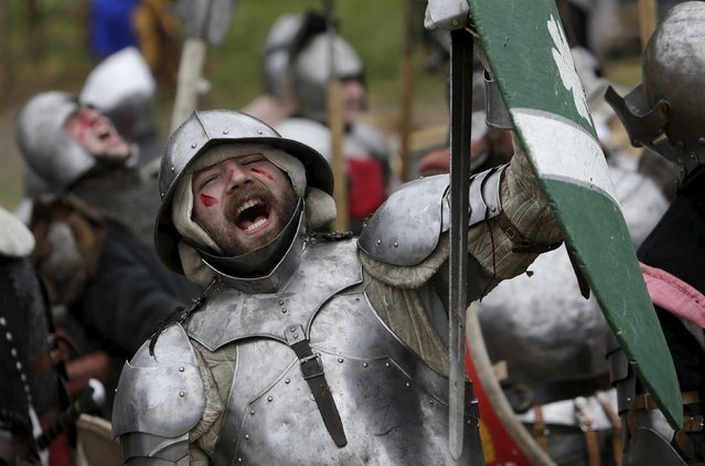 Participant wearing medieval costumes perform during an annual re-enactment of a battle near the village of Libusin, Czech Republic, April 23, 2016. (Photo by David W. Cerny/Reuters)