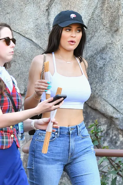 Kylie Jenner enjoys a churro while out at Disneyland with her boyfriend Tyga in Texas, USA on March 8, 2017. (Photo by Fern Sharpshooter/Splash News and Pictures)