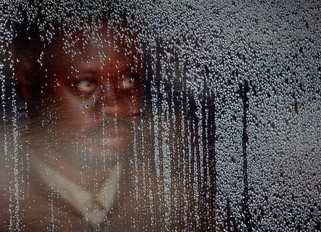 A suspected Ebola patient stands behind a plastic screen at an Ebola treatment centre in Butembo, in the Democratic Republic of Congo, March 28, 2019. (Photo by Baz Ratner/Reuters)