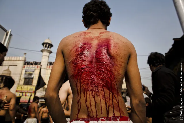 Shi'ite Muslim men and boys beat their chests as they practice self-flagellation during the religious ritual of Ashura in New Delhi, India