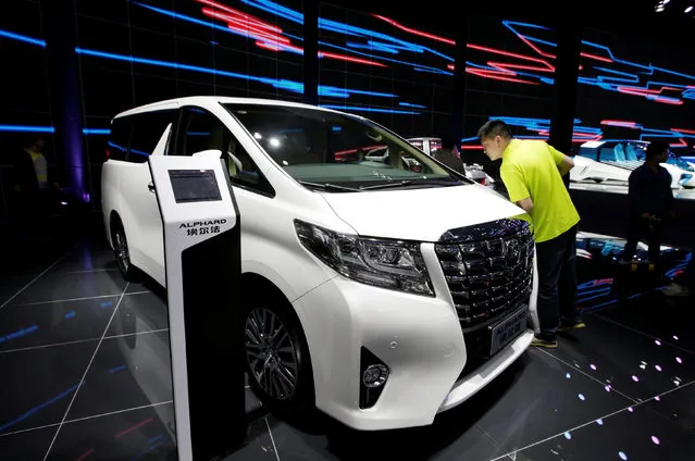 A visitor looks at a Toyota Alphard presented during the Auto China 2016 auto show in Beijing, China May 4, 2016. (Photo by Jason Lee/Reuters)