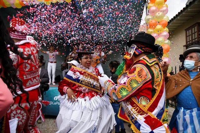 A couple dance during a Pepino's ceremony, a carnival character, as the carnival season kicks off in La Paz, Bolivia, February 6, 2022. (Photo by Claudia Morales/Reuters)
