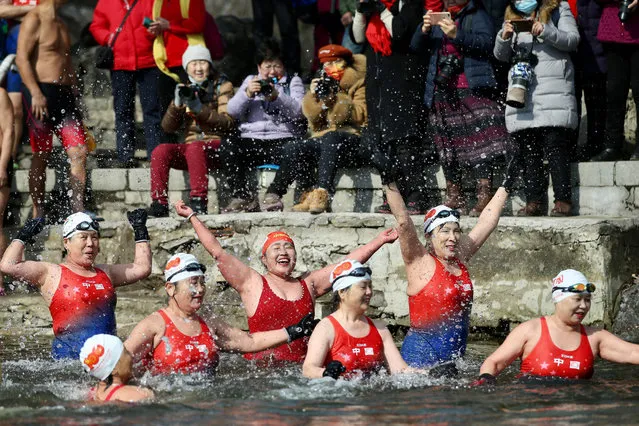 An all-women group of winter swimming enthusiasts swim in a partly-frozen lake as they celebrate International Women's Day in Shenyang, in northeastern China's Liaoning province on March 8, 2022. (Photo by AFP Photo/China Stringer Network)
