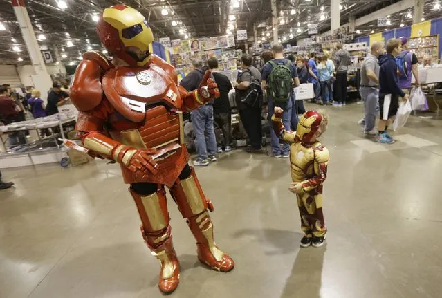 Dave Gwin, left, dressed as Iron Man meets with Ely at the Motor City Comic Con, Friday, May 13, 2016 in Novi, Mich. (Photo by Carlos Osorio/AP Photo)