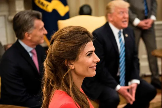 Argentina' s First Lady Juliana Awada (C) and Argentina' s President Mauricio Macri (L) listen while US President Donald Trump speaks to the press before a meeting in the Oval Office of the White House April 27, 2017 in Washington, DC. (Photo by Brendan Smialowski/AFP Photo)
