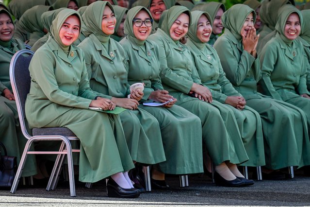 Wives of soldiers from the Indonesian Army's 112th Raider Infantry Battalion attend a ceremony at a military base in Japakeh, Aceh province on June 25, 2024, ahead of their husbands' deployment to Papua province. (Photo by Chaideer Mahyuddin/AFP Photo) 