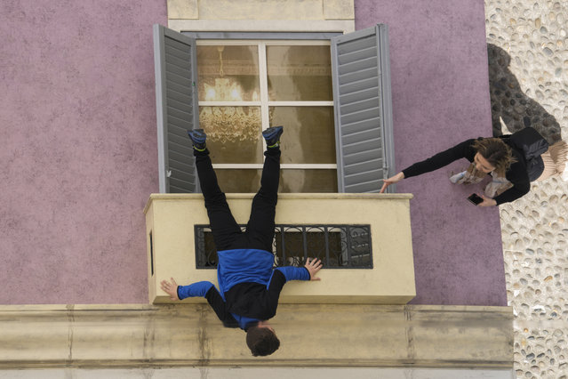 A boy is reflected in a giant mirror as he takes part in the installation by Leandro Erlich at the Palazzo Reale, during the Design Fair exhibition, in Milan, Italy, Saturday, April 22, 2023. (Photo by Luca Bruno/(AP Photo)