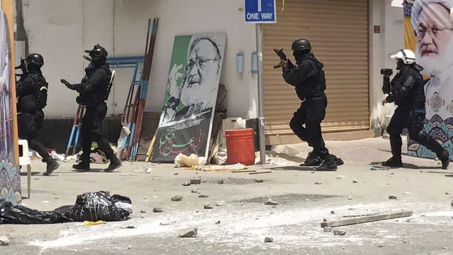 This image provided by an activist who requested to remain unnamed, shows Bahraini security forces during a raid on a sit-in demonstration, in Diraz, Bahrain, Tuesday, May 23, 2017. Bahrain police raided a town where the sit-in has been going on for months in support of Sheikh Isa Qassim, a prominent Shiite cleric, who had his citizenship stripped by the government. An activist said one protester was killed. Bahrain's Interior Ministry said on Twitter Tuesday that the operation targeting Diraz was to “maintain security and public order”. (Photo by AP Photo)