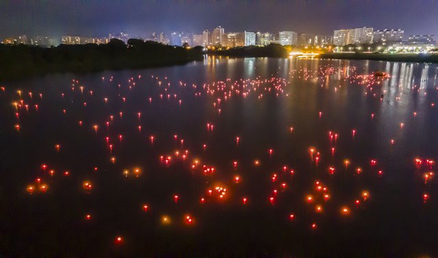 Water lanterns are released on a river to honor ancestors and pray for blessings during the Zhongyuan Festival, the Hungry Ghost Festival, on August 18, 2024 in Qionghai, Hainan Province of China. (Photo by Meng Zhongde/VCG via Getty Images)