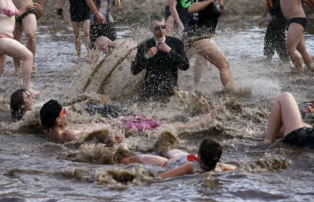 Revelers play in a mud pit during the 21st Woodstock Festival in Kostrzyn-upon-Odra, Poland July 31, 2015. (Photo by Kacper Pempel/Reuters)