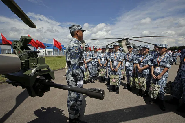 A Chinese soldier introduces the military equipments to visitors after Chinese President Xi Jinping inspected the troops of People's Liberation Army (PLA) Hong Kong Garrison at the Shek Kong Barracks in Hong Kong, Friday, June 30, 2017. (Photo by Kin Cheung/AP Photo)