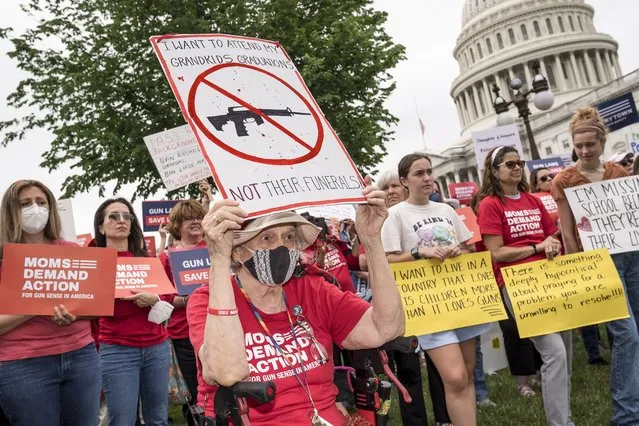 Activists join Senate Democrats outside the Capitol to demand action on gun control legislation after a gunman killed 19 children and two teachers in a Texas elementary school this week, in Washington, Thursday, May 26, 2022. (Photo by J. Scott Applewhite/AP Photo)