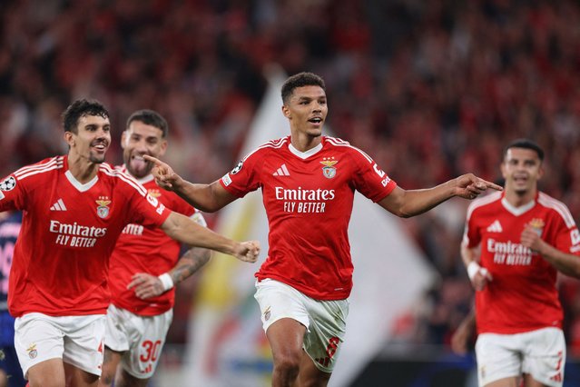 Benfica's Danish defender #06 Alexander Bah (C) celebrates scoring his team's third goal during the UEFA Champions League, league phase day 2 football match between SL Benfica and Club Atletico de Madrid at the Luz stadium in Lisbon on October 2, 2024. (Photo by Filipe Amorim/AFP Photo)