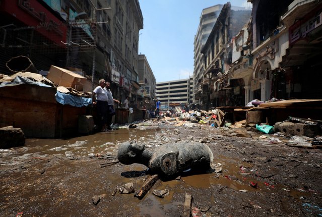 A mannequin part lies near damaged shops in a popular commercial hub area after a major fire in the downtown neighbourhood of Ataba in Cairo, Egypt, on July 26, 2024. (Photo by Mohamed Abd El Ghany/Reuters)