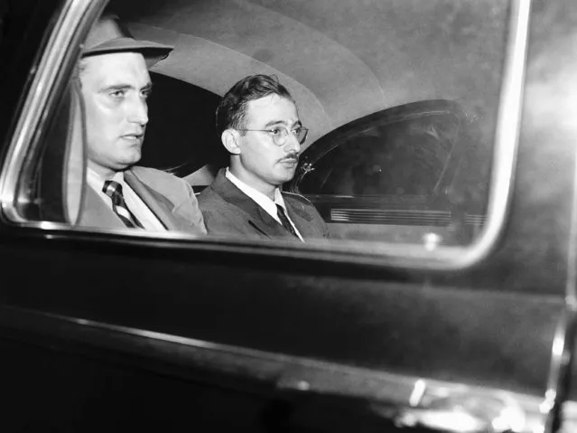 Julius Rosenberg, right, American-born engineer and New York manufacturer, sits in auto with FBI man enroute to federal house of detention in New York City, after his arraignment, July 17, 1950 on charges of conspiring to commit espionage. He is held in $100,000 bail. He was arrested earlier in day by the FBI and accused of recruiting for a Russian-financed atom bomb spy ring. (Photo by Tom Fitzsimmons/AP Photo)