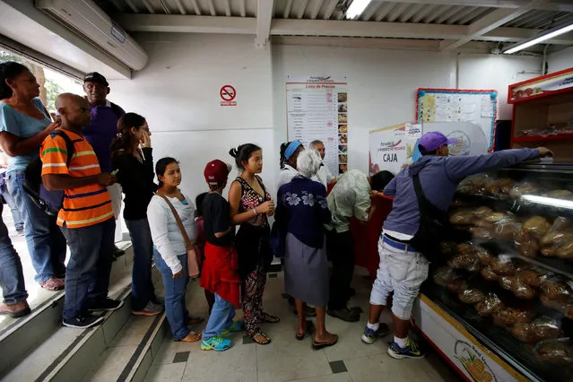 People buy bread at a state-run bakery in Caracas, Venezuela, June 25, 2016. (Photo by Marco Bello/Reuters)