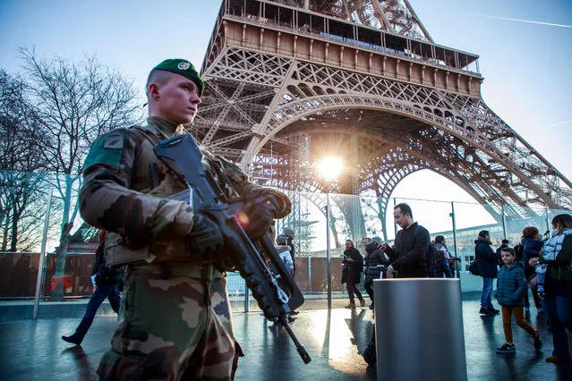 A French soldier from the “Sentinelle military Operation” stands guard as Interior Minister Castaner (unseen) visits the security forces securing the Eiffel Tower to discuss New Year holiday security measures in Paris, France, 30 December 2019. (Photo by Christophe Petit-Tesson/EPA/EFE)