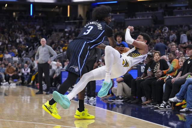 Indiana Pacers guard Tyrese Haliburton (0) and Orlando Magic guard Kentavious Caldwell-Pope (3) fight for the ball during the first half of an NBA basketball game in Indianapolis, Wednesday, November 6, 2024. (Photo by Michael Conroy/AP Photo)