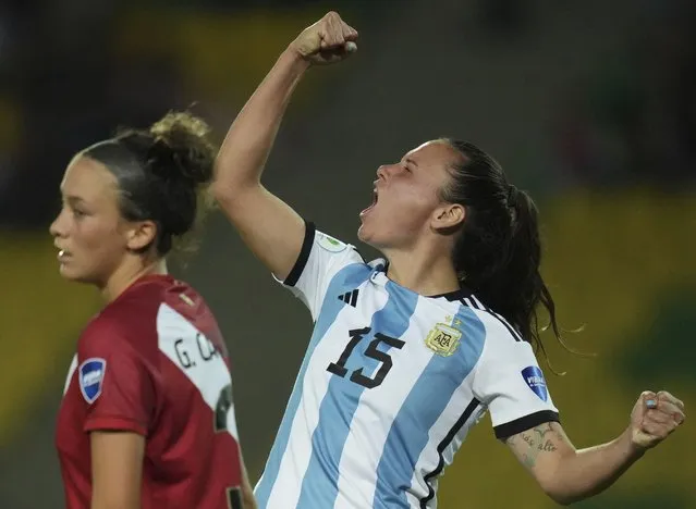 Argentina's Maria Bonsegundo celebrates scoring a goal next to rival Peru's Grace Canigna, during a Women's Copa America soccer match in Armenia, Colombia, Tuesday, July 12, 2022. Argentina went on to win the match 4-0. (Photo by Dolores Ochoa/AP Photo)