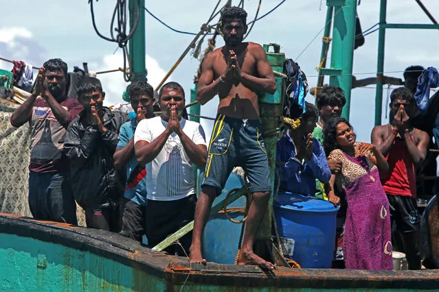 Sri Lankan immigrants gesture on their boat after being rejected by authorities in Aceh, in Lhoknga, Aceh province, Indonesia, June 13, 2016. (Photo by Irwansyah Putra/Reuters/Antara Foto)