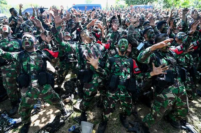 Soldiers from the Iskandar Muda military command sing after a military multi task forces exercise in Jantho, Aceh province on July 6, 2022. (Photo by Chaideer Mahyuddin/AFP Photo)