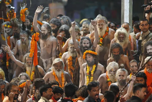 Naked Hindu holy men prepare to bath in the Godavari River during Kumbh Mela, or Pitcher Festival, at Trimbakeshwar in Nasik, India, August 29, 2015. (Photo by Rajanish Kakade/AP Photo)