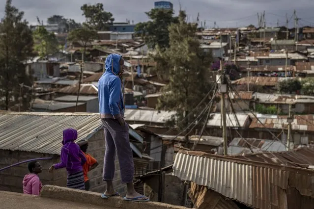 A boy looks out over the Kibera area of Nairobi, Kenya, Friday, August 12, 2022. (Photo by Ben Curtis/AP Photo)