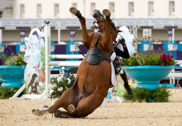 South Korea's Hwang Woojin loses control of his horse during the Show Jumping event of the Modern Pentathlon during the 2012 London Olympics at the Equestrian venue in Greenwich Park, London, on August 11, 2012. (Photo by John MacDougall/AFP)